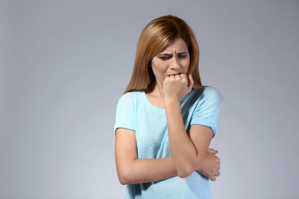 medo do abandono mulher com a mão no queixo e na boca